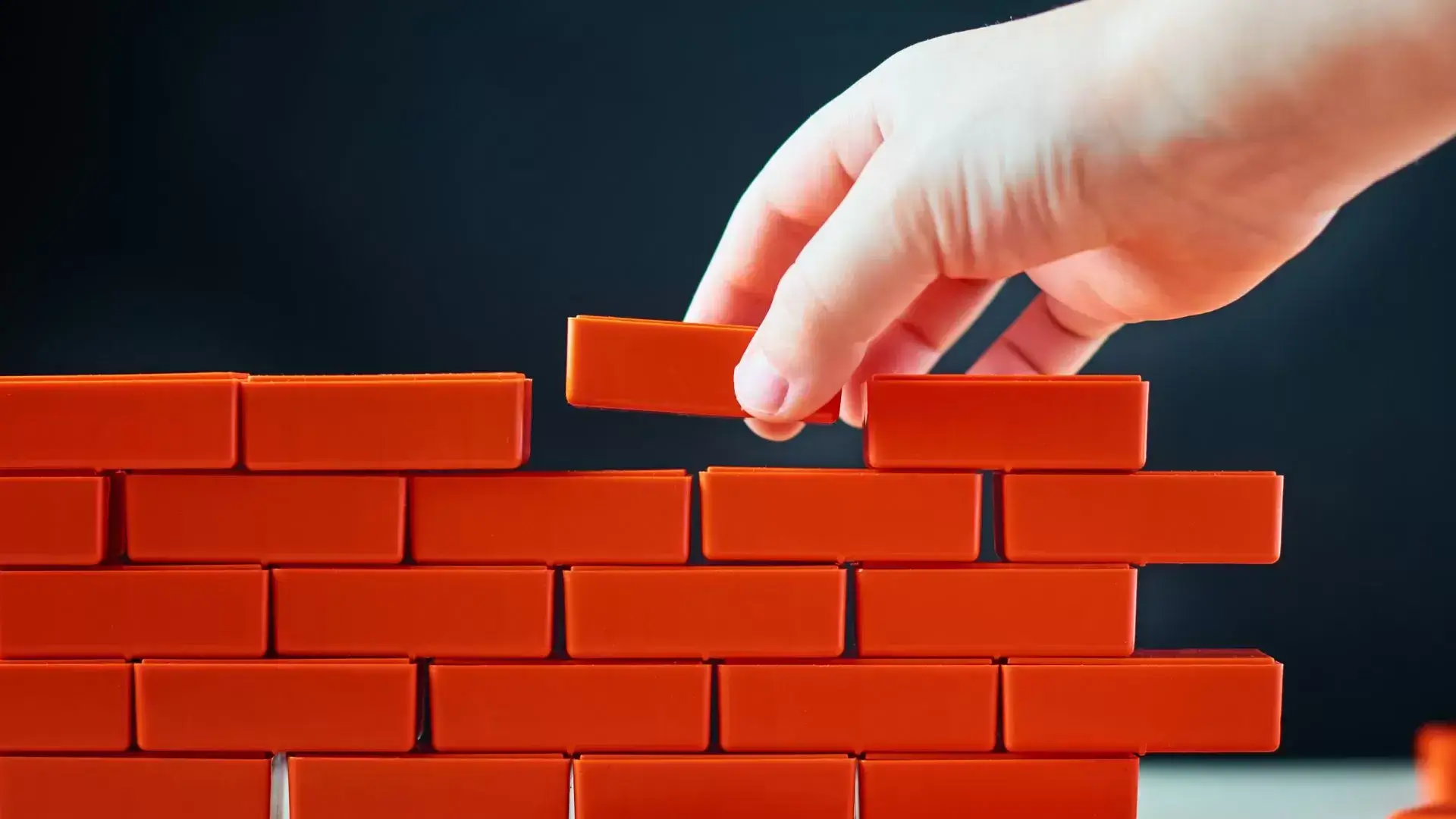 Bricks being carefully stacked, symbolizing the step-by-step process of rediscovering identity and rebuilding confidence after divorce with support from Mississauga Divorce Counselling Therapy.