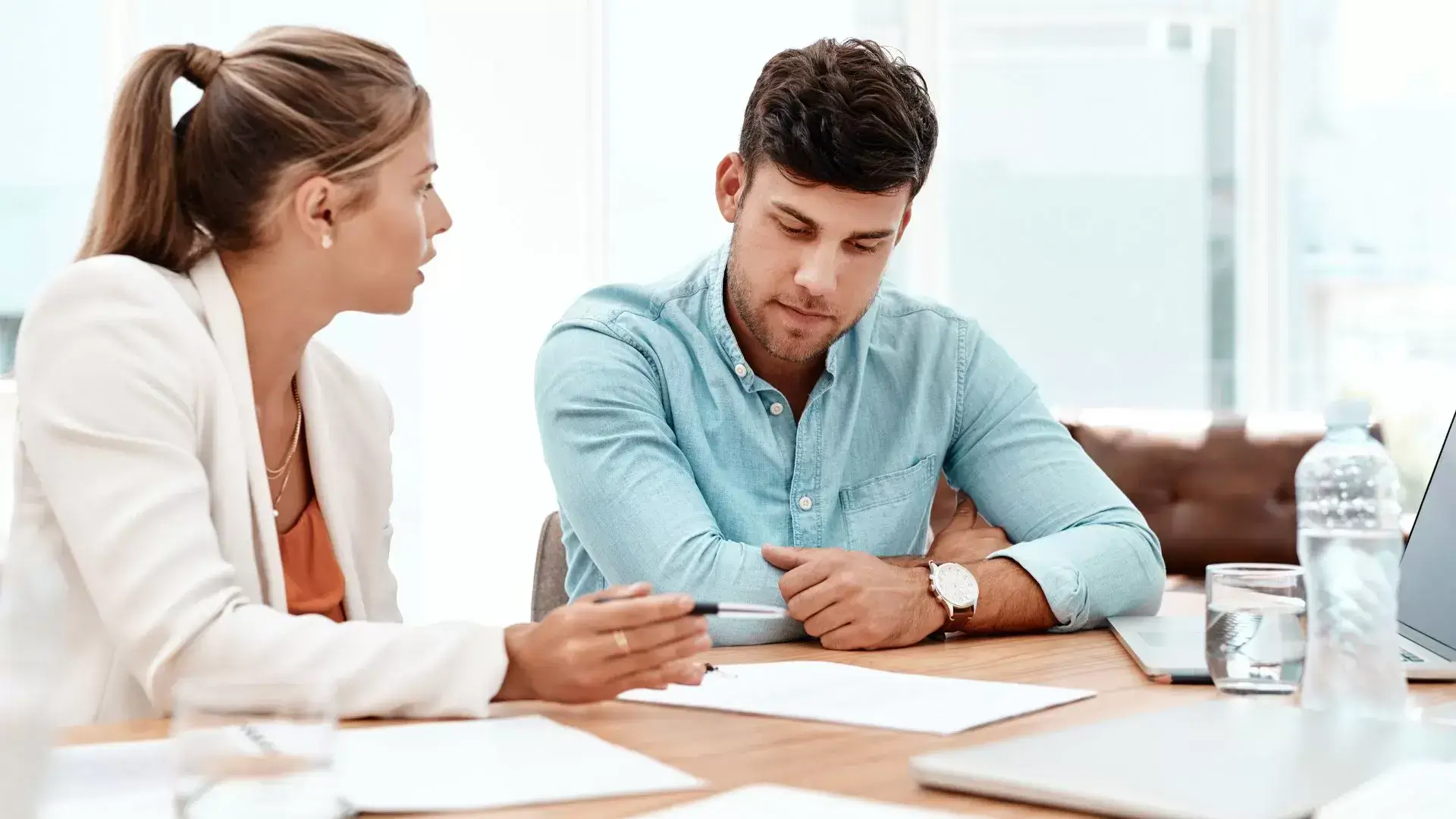 Divorce therapist showing documents to a man during a session at Mississauga Divorce Counselling Therapy, helping him understand the emotional and legal implications of divorce decisions.
