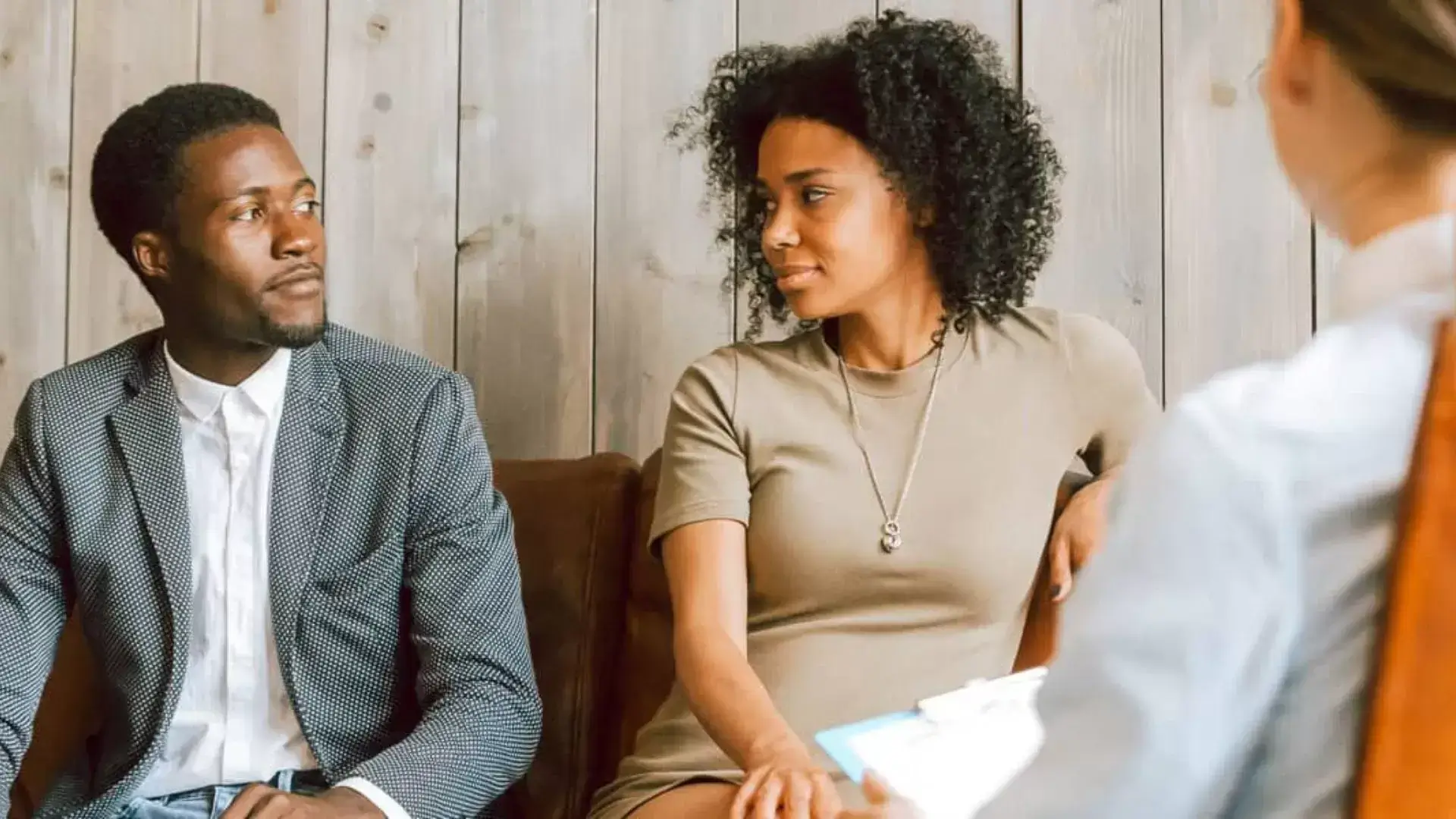 Couple looking at each other while the divorce therapist explains during a Motivational Interviewing session at Oakville Divorce Counselling Therapy, highlighting how MI fosters mutual understanding, motivation for change, and emotionally respectful dialogue in divorce recovery.